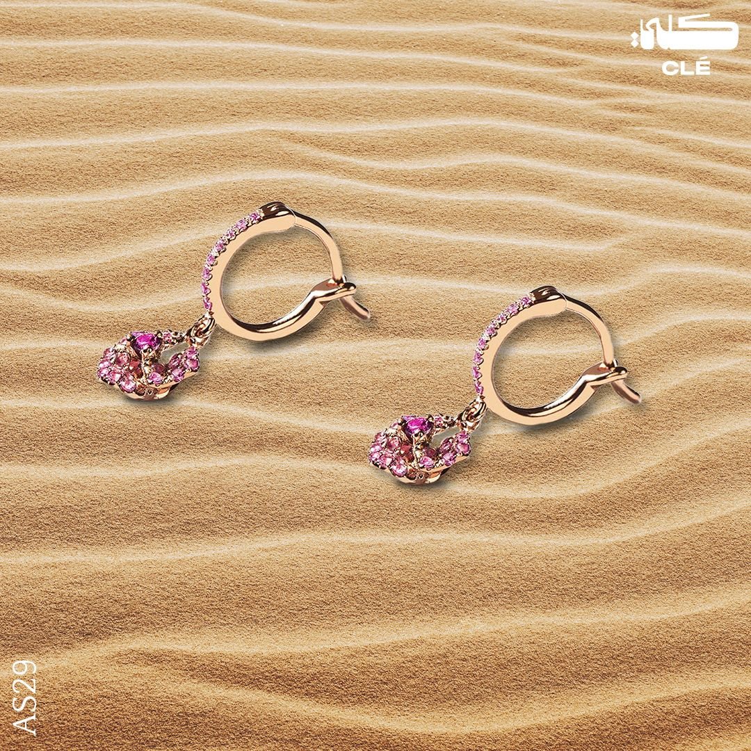 Luxury jewellery design: Pink sapphire hoop earrings on rippled desert sand