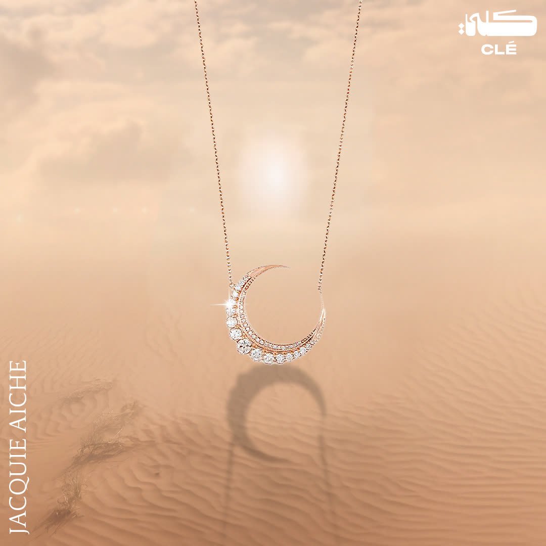 Luxury jewellery design: Diamond crescent moon necklace over a misty desert